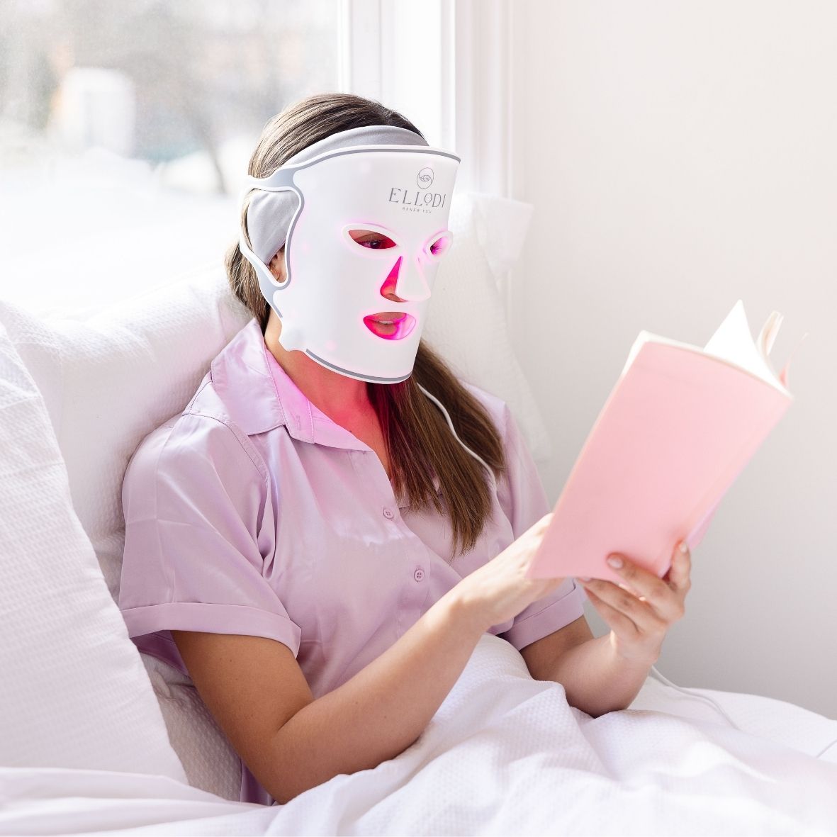 Woman reading with Light Therapy Mask